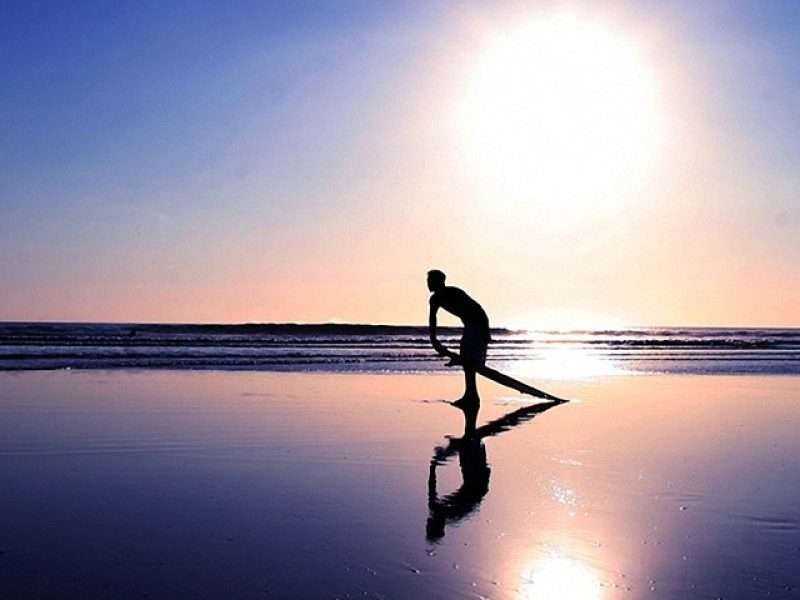 Surfing in Kuta beach, Bali, in the morning