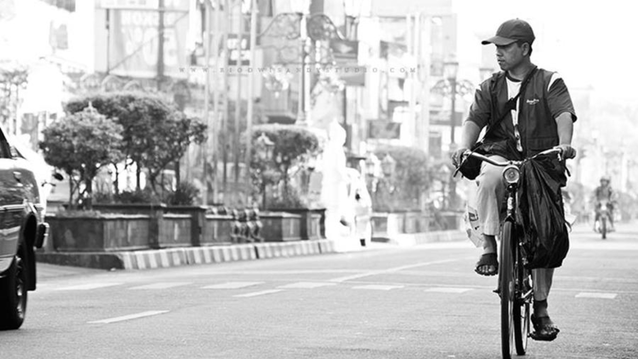 A man cycling on the street, daytime