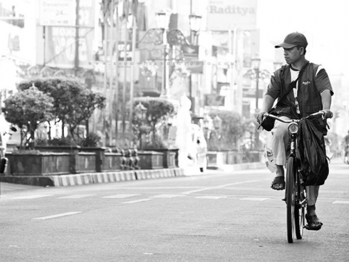 A man cycling on the street, daytime