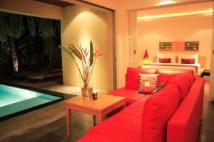 Villa interior with sofa, and pool.