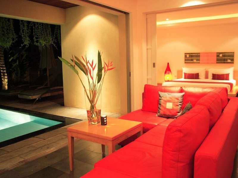 Villa interior with sofa, and pool.